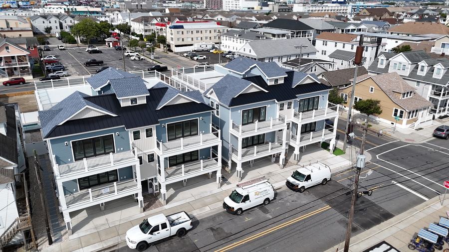Front of the two Kays Oasis homes with white railings and dark gabled roofs