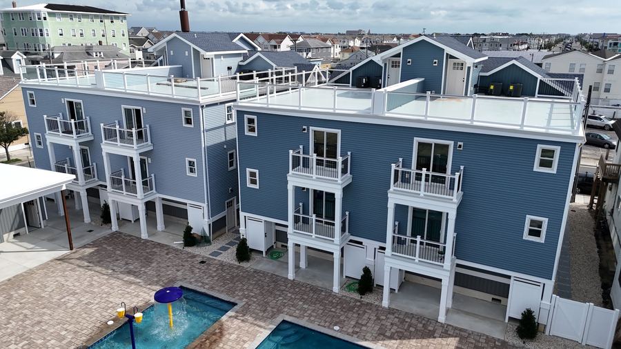 Kays Oasis from the pool side, showing rooftop decks and stacked balconies