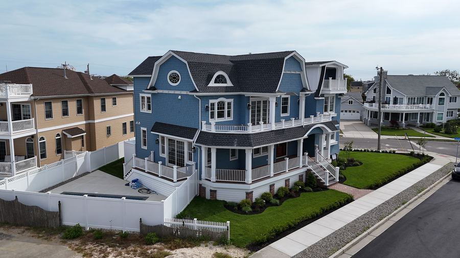 Corner view of the Wildwood Crest home showing the curved porch roof and second-floor balcony