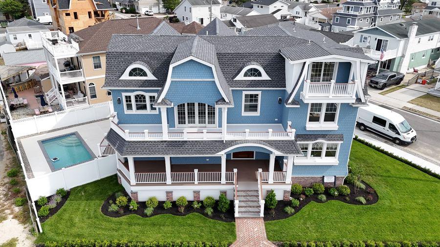 The Wildwood Crest home from above, showing the front porch and the fenced pool beside the house